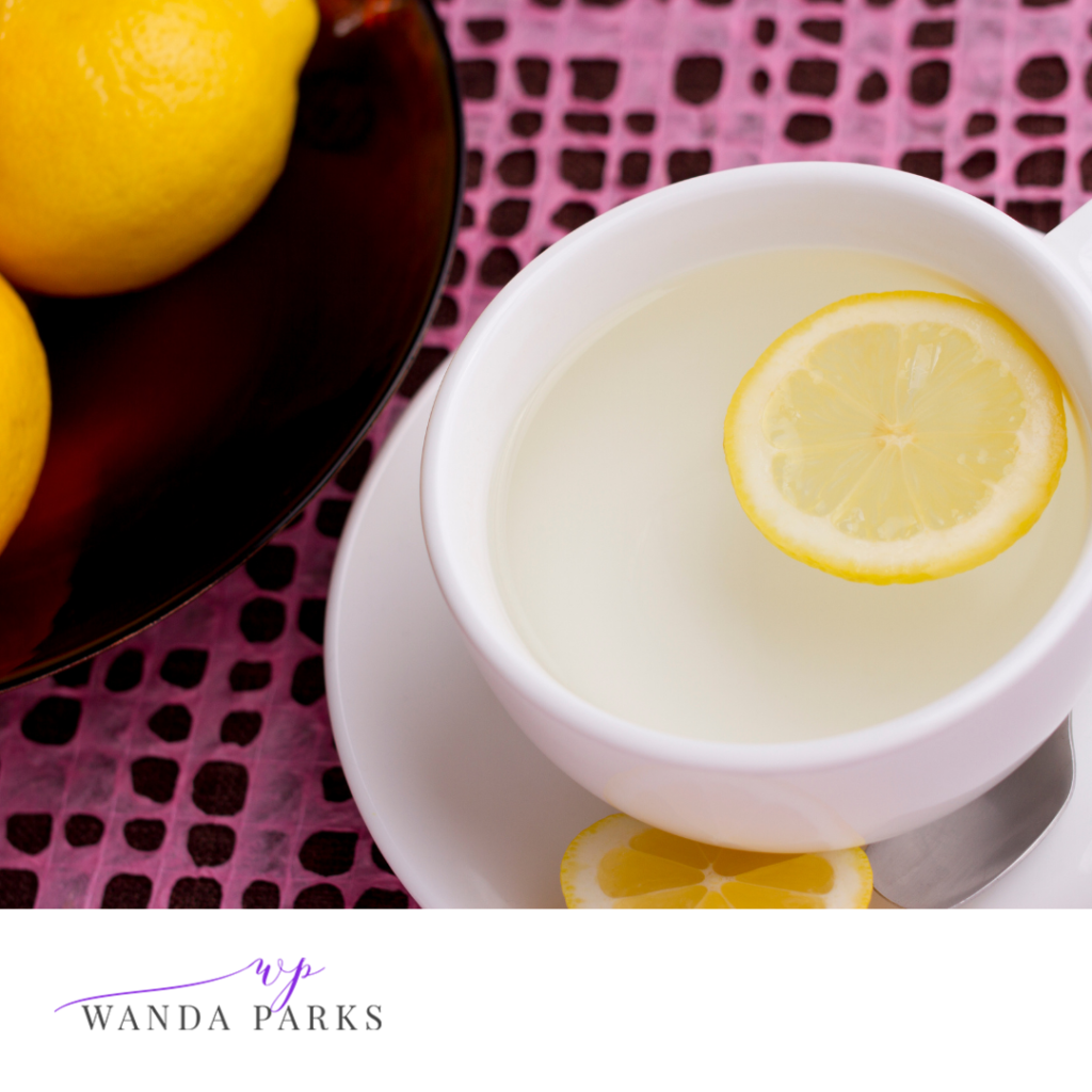 White porcelain tea cup filled with hot lemon water, 